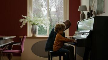 Mature man teaching grandson piano photo