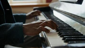 Close up of mature man playing piano photo