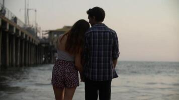 Portrait of young couple watching sea photo