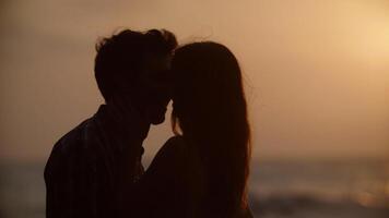 Portrait of young couple kissing on beach photo