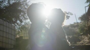 Portrait of father holding daughter in sunlight photo