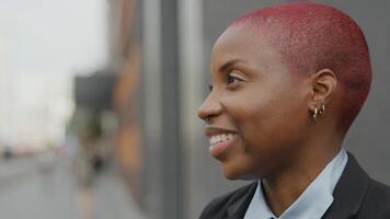 Young businesswoman with shaved pink hair talking photo