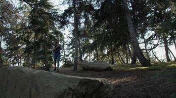 Portrait of young woman running in woods photo