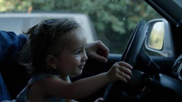 Portrait of girl playing with steering wheel photo