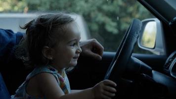 Portrait of girl playing with steering wheel photo