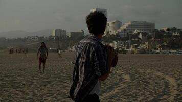 Portrait of men playing with ball on beach photo