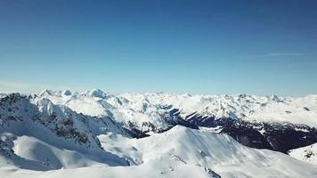 Aerial drone view of snow covered mountains in the winter. video