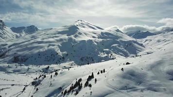 Aerial drone view of snow covered mountains in the winter. video