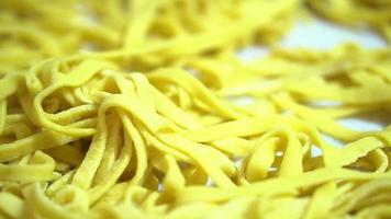 freshly made pasta spread out on the kitchen table before cooking . semi-finished products video