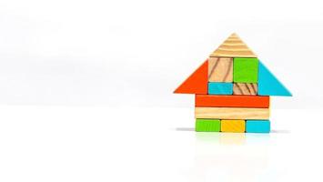 Close up multi colored wooden blocks form a house shape