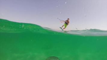 un hombre haciendo kitesurf sobre una medusa. video