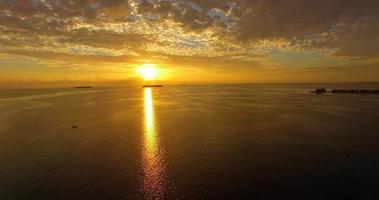 Aerial drone view of a scenic tropical island in the Maldives at sunset. video