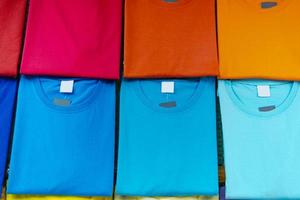 Close up of Colorful t-shirts on hangers photo