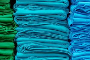 Close up of Colorful t-shirts stacked on shelves photo