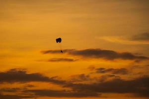 The silhouette of the paramotor at sunset photo