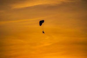 The silhouette of the paramotor at sunset photo