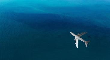 Aerial top view of Airplane flies over a sea, view from above photo