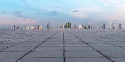 Panoramic empty concrete floor and skyline with buildings photo