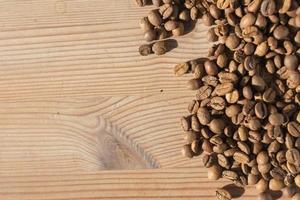 Coffe beans on the wooden background photo