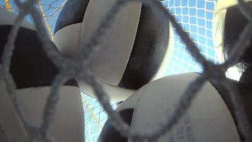 POV of a woman beach volleyball player putting the balls in a bag.