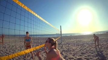 pov de jugadoras jugando voleibol de playa con una chica que se zambulle para cavar una pelota.