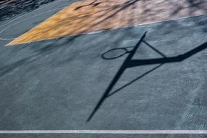 street basketball hoop shadows on the court photo