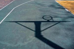 street basketball hoop shadows on the court photo