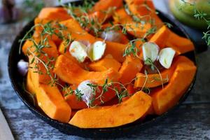 Pieces of pumpkin in a skillet before baking photo