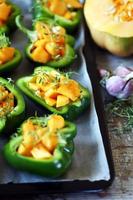Green peppers stuffed with pumpkin pieces photo