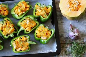 Green peppers stuffed with pumpkin pieces photo