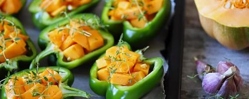 Green peppers stuffed with pumpkin pieces photo