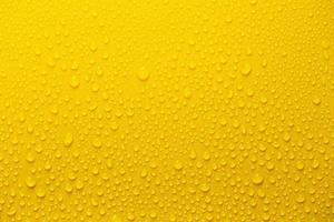 Rain or Water drops on yellow background photo