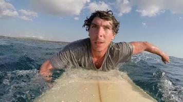 pov de un surfista zambulléndose en un taxi acuático acuático en su tabla de surf. video