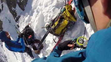 POV of a man ice climbing on snow in the mountains. video
