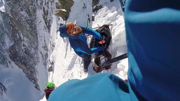 POV of a man ice climbing on snow in the mountains. video