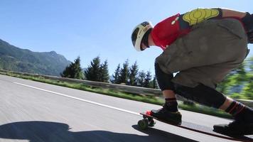 A skateboarder downhill skateboarding racing on a mountain road.