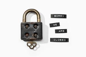 Padlock with label sorry we are closed isolated on white background. Closed by coronavirus or covid-19 concept photo