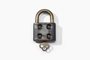 Antique padlock isolated on white background. Closed concept photo