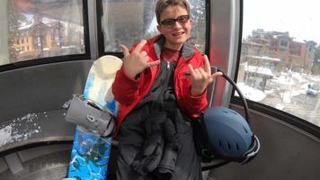 POV of a boy and his mother on a gondola lift at a ski resort. video