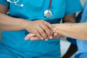 Holding hands Asian senior or elderly old lady woman patient with love, care, encourage and empathy at nursing hospital ward, healthy strong medical concept photo