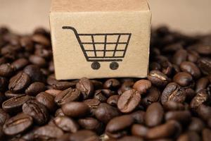 Box with shopping cart logo symbol on coffee beans, Import Export Shopping online or eCommerce delivery service store product shipping, trade, supplier concept. photo