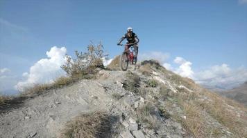 Mountain biker biking downhill in the mountains. video
