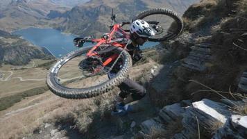 Mountain biker carries his bike up the mountains trail. video