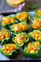 Green peppers stuffed with pumpkin pieces photo