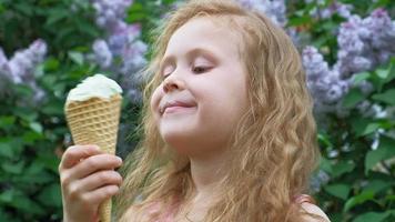 Little girl eats ice cream outdoors Summer
