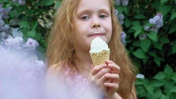 Little girl eats ice cream outdoors Summer