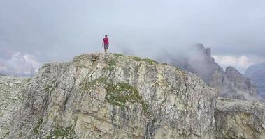 Aerial drone view of a man hiking in the mountains. video