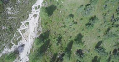 Aerial drone view of a group of people hiking in the mountains. video