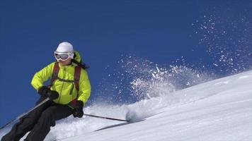 A woman skiing on powder snow covered mountains. video