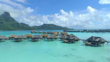 Aerial drone view of a luxury resort and overwater bungalows in Bora Bora tropical island. video